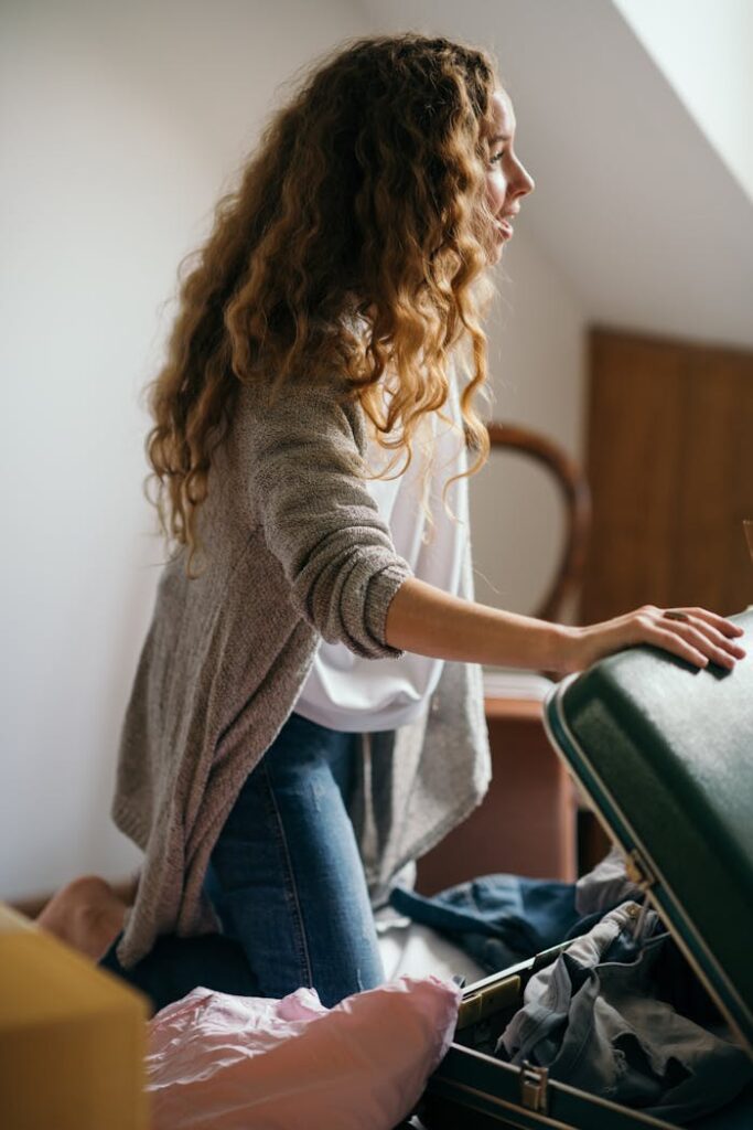 pexels-photo-4247725 Focused woman packing suitcase in bedroom